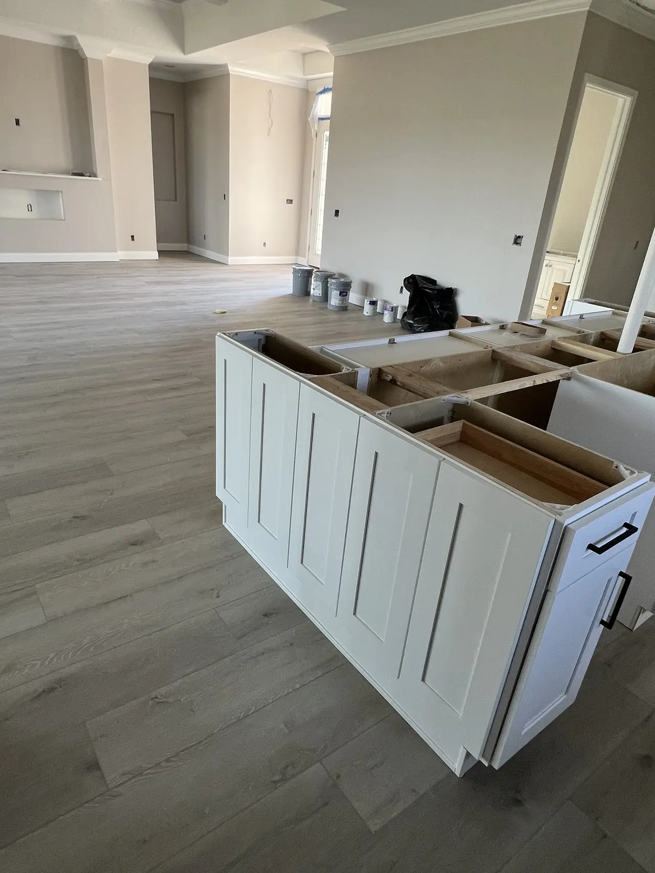 White shaker kitchen during installation in a Tampa home, before countertops