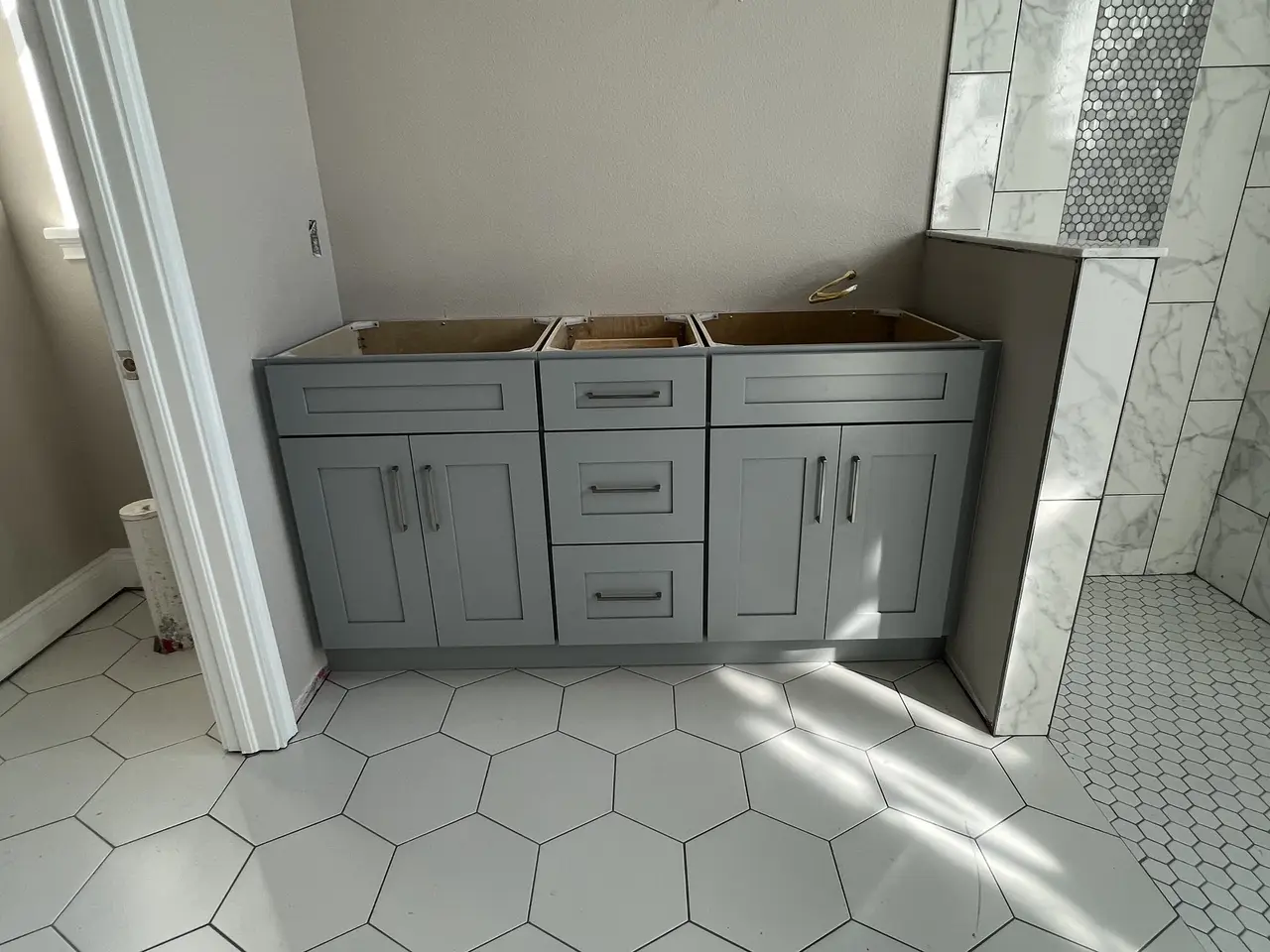 Gray shaker kitchen cabinets over hex tile flooring in Tampa Bay
