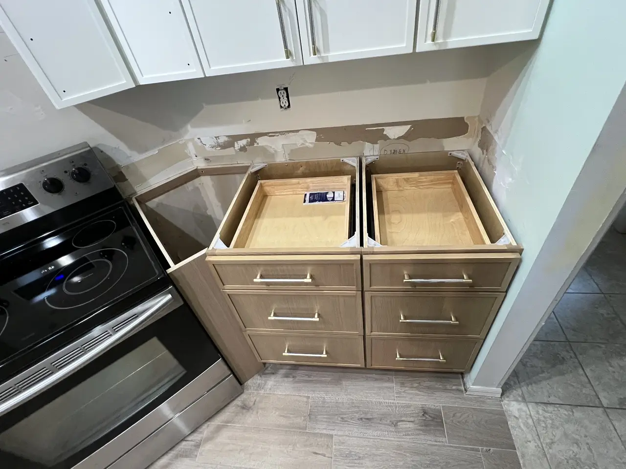 Natural wood cabinet drawers with soft-close in a two-tone Tampa kitchen