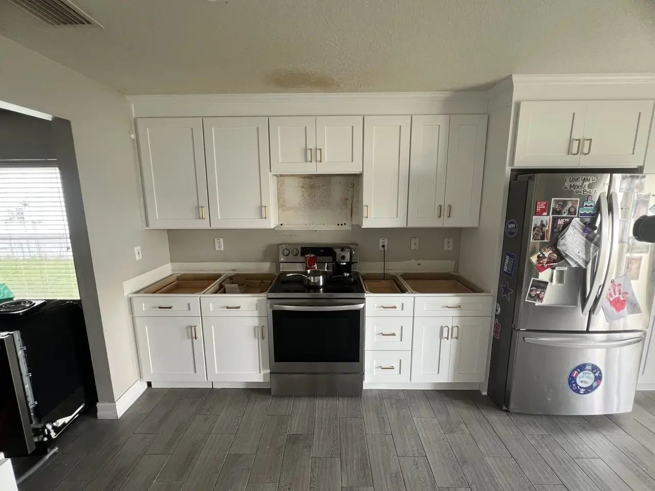 Bright white kitchen cabinets with stainless refrigerator in Tampa