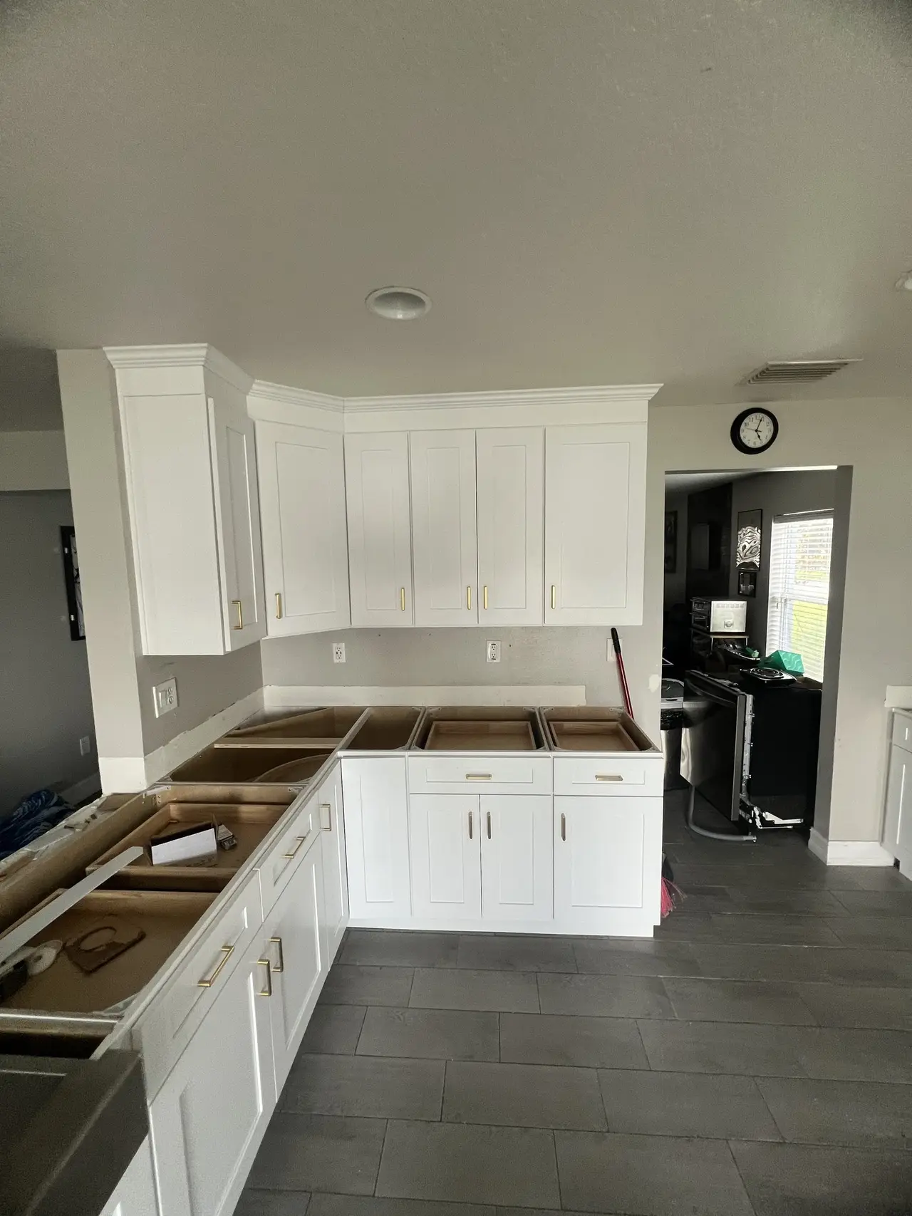 L-shaped white kitchen cabinets in a Tampa remodel