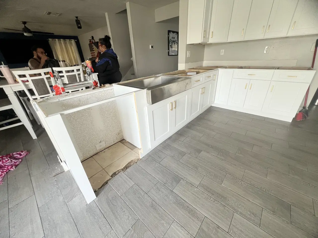 Installation crew setting and leveling kitchen cabinets in a Tampa home